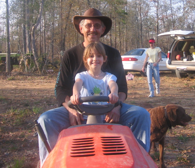 Jessica and Grandpa Dale (with Dale's dog, Bud, at his side) and Leah walking in the background (January 1, 2006)