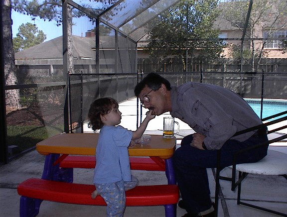 Samantha feeding Grandpa Dale barbecued chicken (2000)